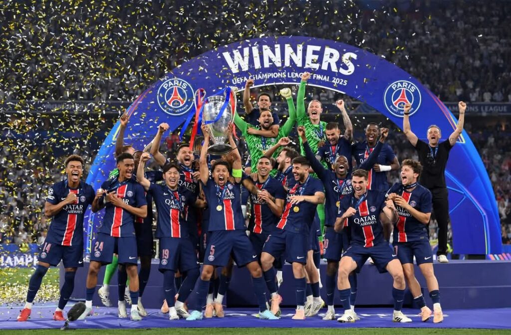 PSG team celebrating and holding the UEFA Champions League trophy after their 2025 final victory over Inter Milan